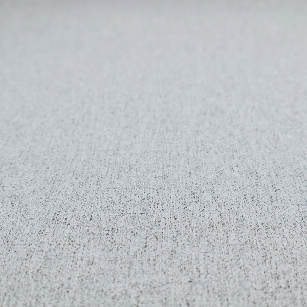 A light grey upholstery fabric with a dense, speckled textured weave.