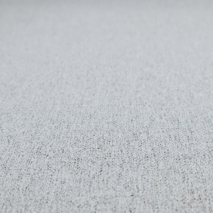 A light grey upholstery fabric with a dense, speckled textured weave.