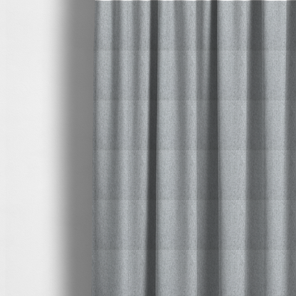 The fabric used to create these made-to-measure curtains is a light grey upholstery fabric with a dense, speckled textured weave.