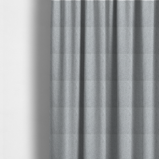 The fabric used to create these made-to-measure curtains is a light grey upholstery fabric with a dense, speckled textured weave.