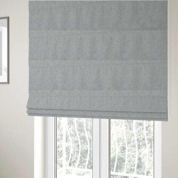The fabric used to create these Roman blinds is a light grey upholstery fabric with a dense, speckled textured weave.