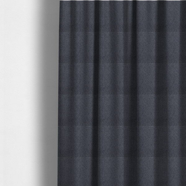 The fabric used to create these made-to-measure curtains is a charcoal grey upholstery fabric with a dense, diagonal twill weave.