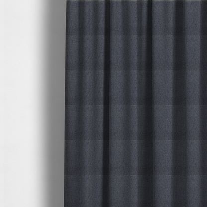 The fabric used to create these made-to-measure curtains is a charcoal grey upholstery fabric with a dense, diagonal twill weave.