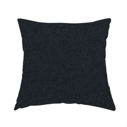 The fabric used to create this handmade cushion is a midnight black upholstery fabric with a dense, diagonal twill weave.