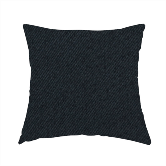 The fabric used to create this handmade cushion is a midnight black upholstery fabric with a dense, diagonal twill weave.