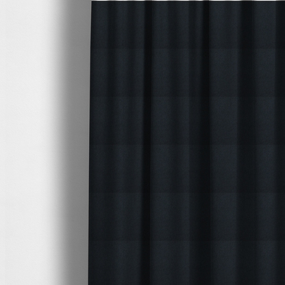 The fabric used to create these made-to-measure curtains is a midnight black upholstery fabric with a dense, diagonal twill weave.