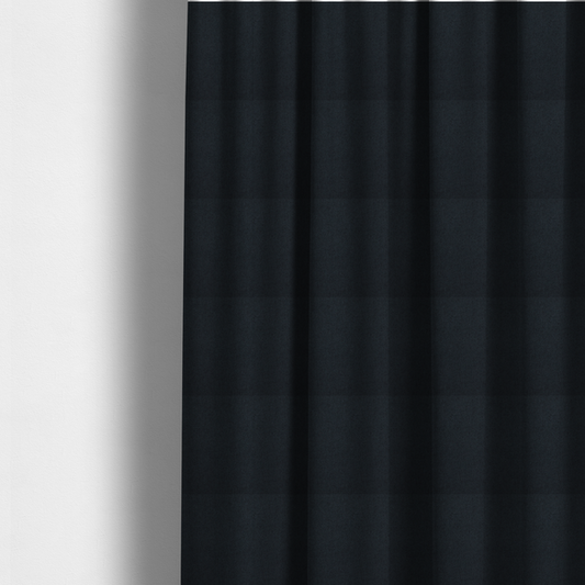 The fabric used to create these made-to-measure curtains is a midnight black upholstery fabric with a dense, diagonal twill weave.