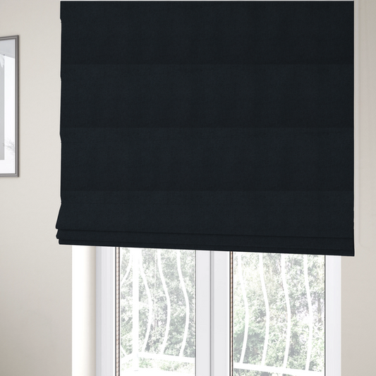 The fabric used to create these Roman blinds is a midnight black upholstery fabric with a dense, diagonal twill weave.