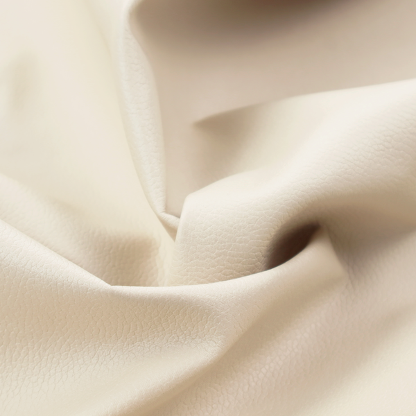 Boston Faux Leather Upholstery Fabric in a soft beige colour, showcasing a fine pebbled texture.