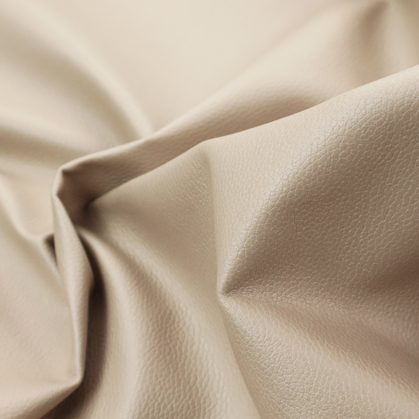 Boston Faux Leather Upholstery Fabric in a warm beige tone, showcasing a fine, textured leather grain.