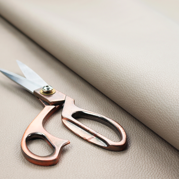 Boston Faux Leather Upholstery Fabric in a taupe-beige colour, showing a prominent pebbled grain texture.