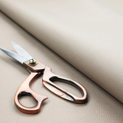 Boston Faux Leather Upholstery Fabric in a taupe-beige colour, showing a prominent pebbled grain texture.