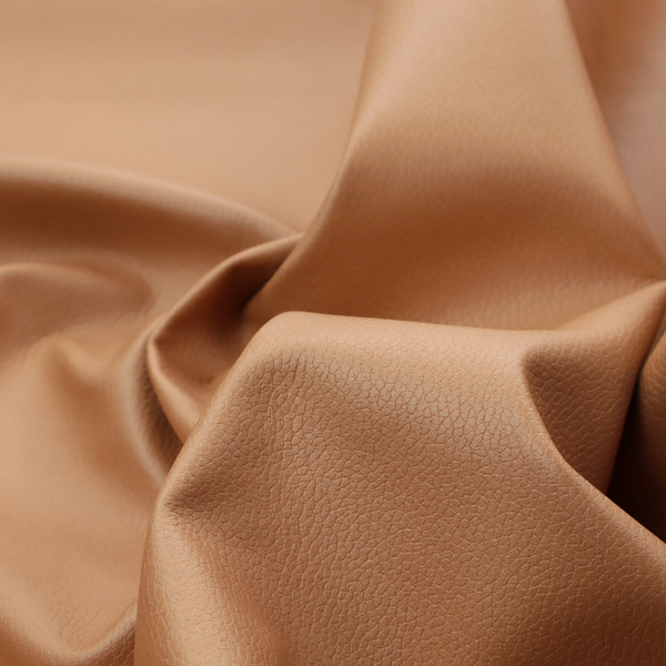 Boston Faux Leather Upholstery Fabric in a warm tan colour, showcasing a fine pebbled grain texture.