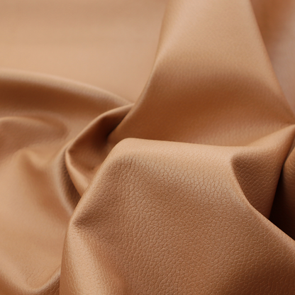 Boston Faux Leather Upholstery Fabric in a warm tan colour, showcasing a fine pebbled grain texture.