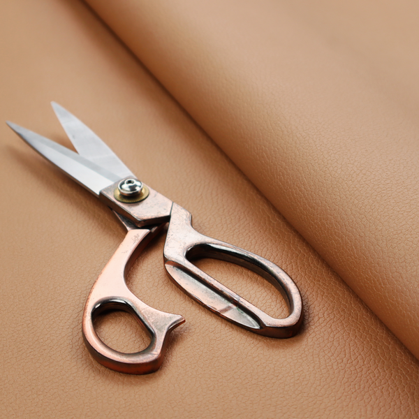 Boston Faux Leather Upholstery Fabric in a warm tan colour, showcasing a fine pebbled grain texture.