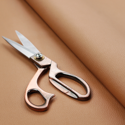 Boston Faux Leather Upholstery Fabric in a warm tan colour, showcasing a fine pebbled grain texture.