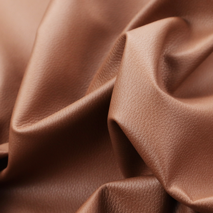 Boston Faux Leather Upholstery Fabric in a rich tan colour, showcasing a fine, textured leather grain.
