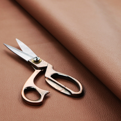 Boston Faux Leather Upholstery Fabric in a rich tan colour, showcasing a fine, textured leather grain.