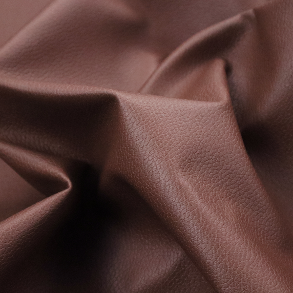 Boston Faux Leather Upholstery Fabric in a deep reddish-brown colour, showcasing a fine pebbled grain texture.