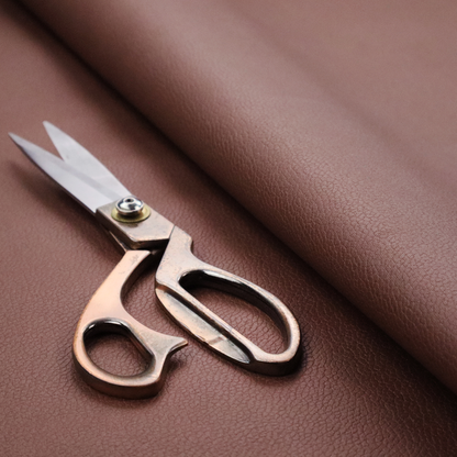 Boston Faux Leather Upholstery Fabric in a deep reddish-brown colour, showcasing a fine pebbled grain texture.