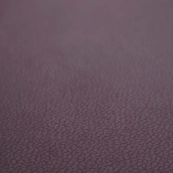Boston Faux Leather Upholstery Fabric in a deep aubergine purple colour, showcasing a fine pebbled grain texture.