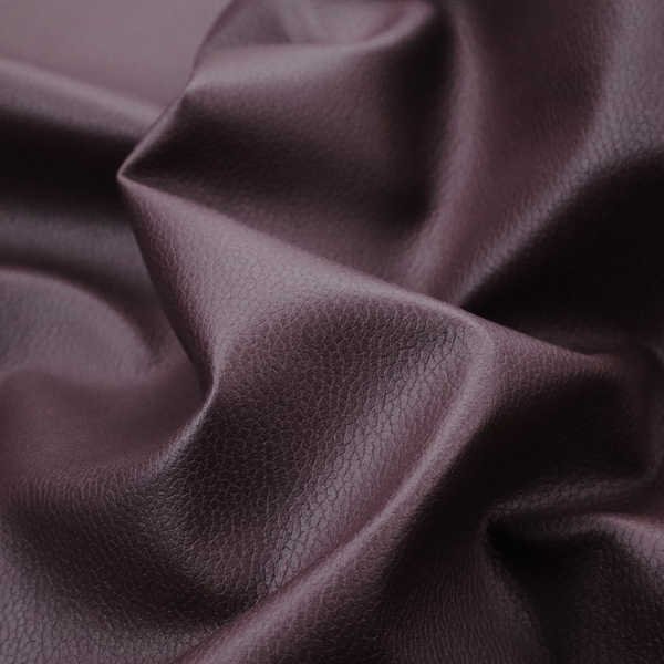 Boston Faux Leather Upholstery Fabric in a deep aubergine purple colour, showcasing a fine pebbled grain texture.