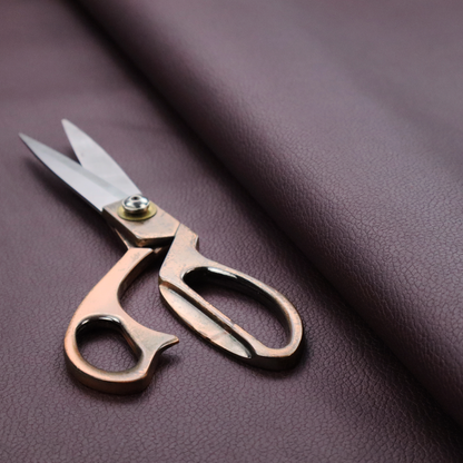 Boston Faux Leather Upholstery Fabric in a deep aubergine purple colour, showcasing a fine pebbled grain texture.