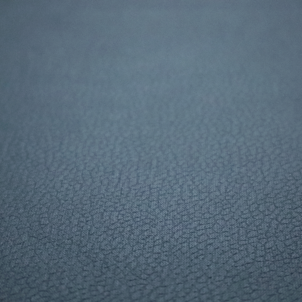 Boston Faux Leather Upholstery Fabric in a slate blue colour, showcasing a fine pebbled grain texture.