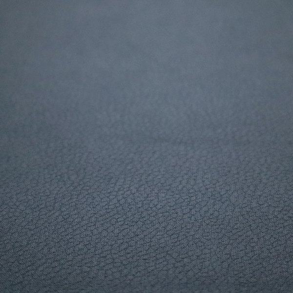 Boston Faux Leather Upholstery Fabric in a deep steel blue colour, highlighting a fine pebbled grain texture.
