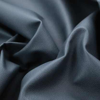 Boston Faux Leather Upholstery Fabric in a deep steel blue colour, highlighting a fine pebbled grain texture.