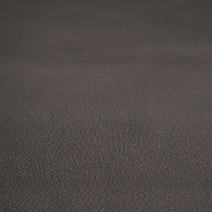 Boston Faux Leather Upholstery Fabric in a deep dark green colour, showcasing a fine pebbled grain texture.