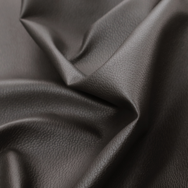 Boston Faux Leather Upholstery Fabric in a deep dark green colour, showcasing a fine pebbled grain texture.