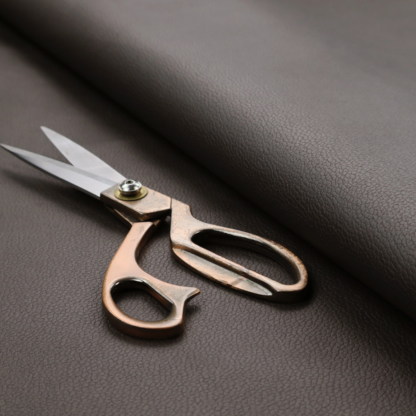 Boston Faux Leather Upholstery Fabric in a deep dark green colour, showcasing a fine pebbled grain texture.