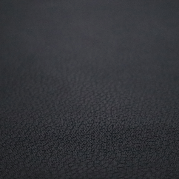 Boston Faux Leather Upholstery Fabric in a deep black colour, showcasing a fine pebbled grain texture.