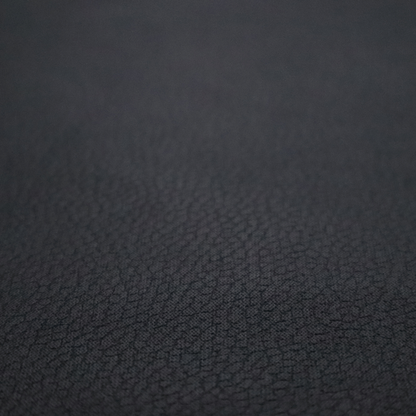 Boston Faux Leather Upholstery Fabric in a deep black colour, showcasing a fine pebbled grain texture.