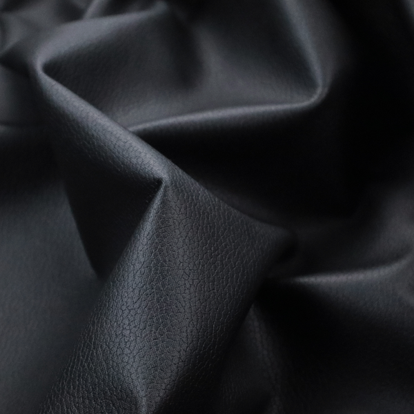 Boston Faux Leather Upholstery Fabric in a deep black colour, showcasing a fine pebbled grain texture.