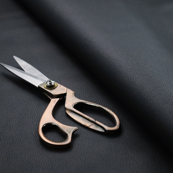 Boston Faux Leather Upholstery Fabric in a deep black colour, showcasing a fine pebbled grain texture.