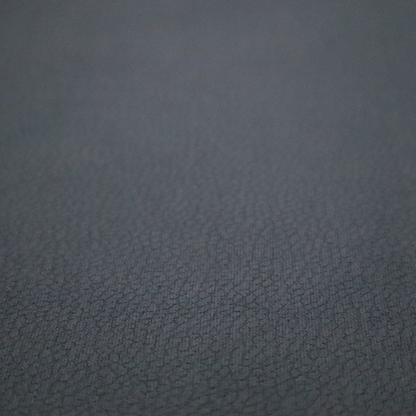 Boston Faux Leather Upholstery Fabric in a deep charcoal grey colour, showcasing a fine pebbled grain texture.