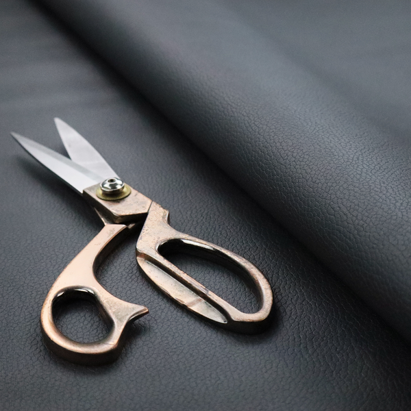 Boston Faux Leather Upholstery Fabric in a deep charcoal grey colour, showcasing a fine pebbled grain texture.