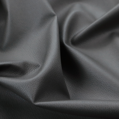 Boston Faux Leather Upholstery Fabric in a mid grey colour, showcasing a fine pebbled grain texture.