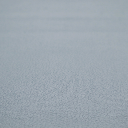 Boston Faux Leather Upholstery Fabric in a light grey colour, showcasing a fine pebbled grain texture.