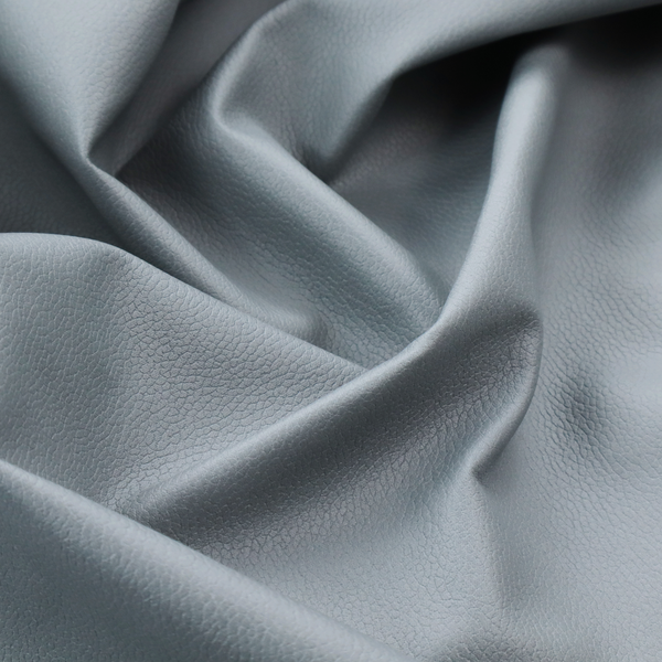 Boston Faux Leather Upholstery Fabric in a light grey colour, showcasing a fine pebbled grain texture.