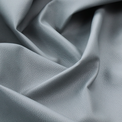 Boston Faux Leather Upholstery Fabric in a light grey colour, showcasing a fine pebbled grain texture.