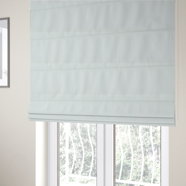 The fabric used to create these Roman blinds is a solid white fabric with a distinct, tightly woven grid texture. The material features a uniform, grid-like pattern of tiny raised squares, reminiscent of Aida cloth or a textured linen blend, creating a subtle, clean, and matte finish across the entire surface.