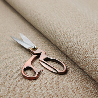A beige or light taupe fabric featuring a distinct, tightly woven grid texture. The material showcases a multi-tonal, basket-weave style pattern with blending neutral threads, creating a warm, organic, and matte finish across the entire surface.