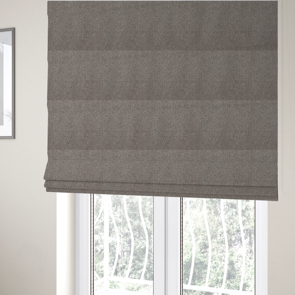 The fabric used to create these Roman blinds is a taupe or light greyish-brown fabric featuring a distinct, tightly woven grid texture. The material showcases a multi-tonal, basket-weave style pattern with blending neutral threads, creating a soft, heathered, and matte finish across the entire surface.