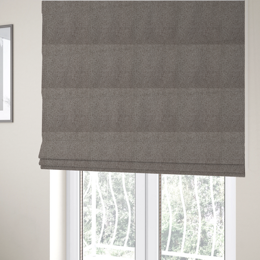 The fabric used to create these Roman blinds is a taupe or light greyish-brown fabric featuring a distinct, tightly woven grid texture. The material showcases a multi-tonal, basket-weave style pattern with blending neutral threads, creating a soft, heathered, and matte finish across the entire surface.