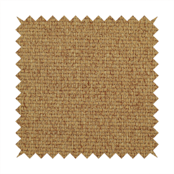 A golden brown or mustard fabric featuring a distinct, tightly woven grid texture. The material showcases a multi-tonal, basket-weave style pattern with blended ochre and tan threads, creating a warm, vibrant, and matte finish across the entire surface.
