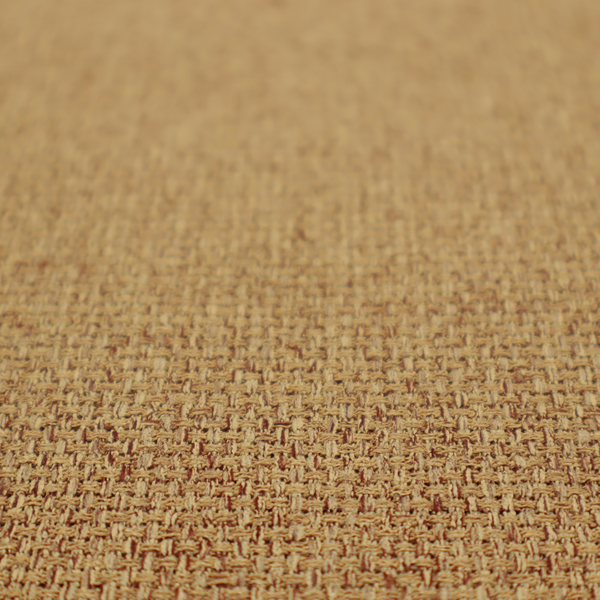 A golden brown or mustard fabric featuring a distinct, tightly woven grid texture. The material showcases a multi-tonal, basket-weave style pattern with blended ochre and tan threads, creating a warm, vibrant, and matte finish across the entire surface.