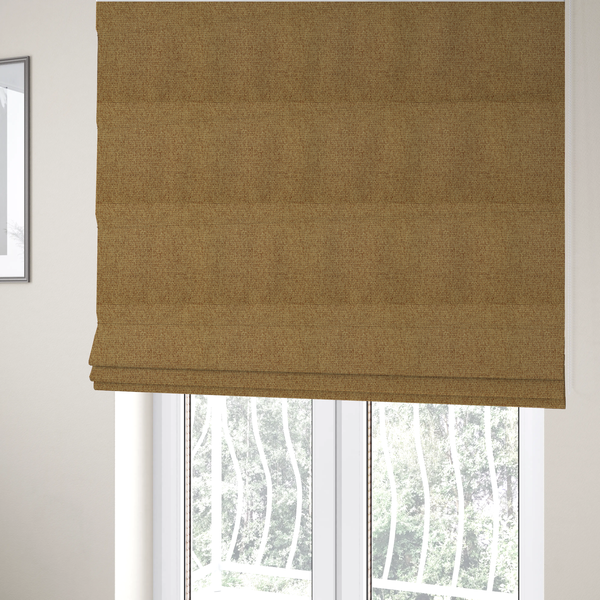 The fabric used to create these Roman blinds is a golden brown or mustard fabric featuring a distinct, tightly woven grid texture. The material showcases a multi-tonal, basket-weave style pattern with blended ochre and tan threads, creating a warm, vibrant, and matte finish across the entire surface.